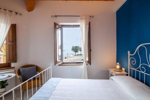 a bedroom with a bed and a window at Sirolo Sea rooms in Sirolo