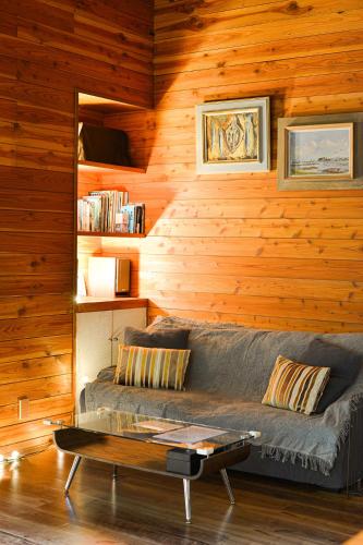 a living room with a couch and a coffee table at KOMOREBI House -北軽井沢 木漏れ日の家- ペット可 in Kita-karuizawa