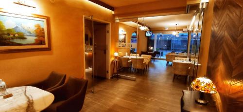 a restaurant with a dining room with tables and a mirror at THEMIS BEACH in Paralia Katerinis