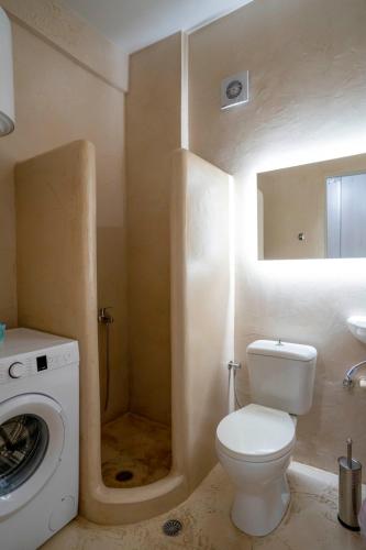 a bathroom with a toilet and a washing machine at Central House Karistos in Karistos