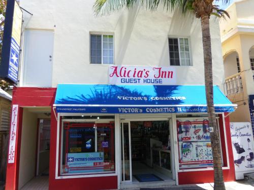 a store with a palm tree in front of it at Alicia's Inn in Philipsburg