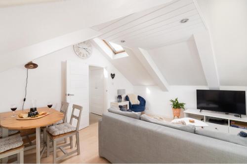 a living room with a couch and a table at Stunning Views Over Mounts Bay with Balcony in Penzance