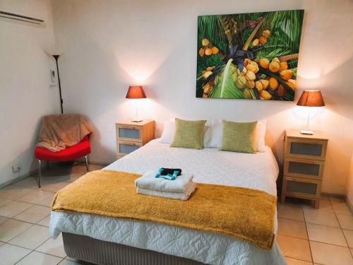 a bedroom with a bed and a painting on the wall at M104 West Perth Studio Apartment near Kings Park in Perth