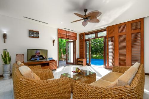 a living room with a couch and a table at Tropical Pool Villas Da Nang in Da Nang