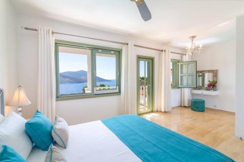 a bedroom with a bed and a large window at Spacious 5 Bedroom Villa with Private Pool in Kas