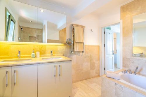 a bathroom with two sinks and a tub and a mirror at Spacious 5 Bedroom Villa with Private Pool in Kas