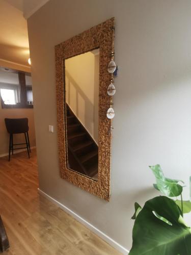 a mirror hanging on a wall in a room at Ferienhaus zur Weinfee in Briedel