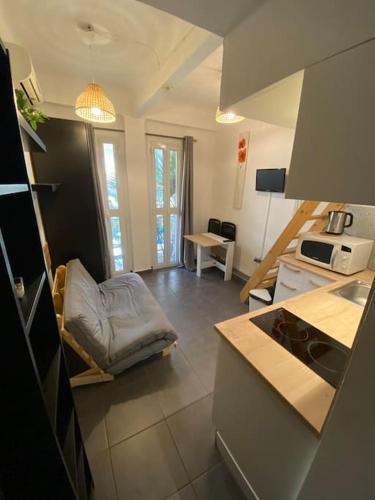 - une cuisine avec un canapé au milieu d'une pièce dans l'établissement Studio Juan les Pins 06 - centre ville - plage à 150m, à Antibes