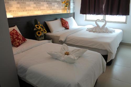 Postel nebo postele na pokoji v ubytování Signature Hotel @ Bangsar South