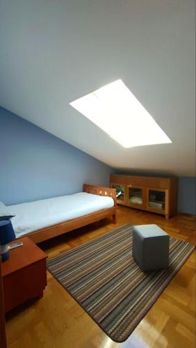 a bedroom with a bed and a large skylight at Nossa Casa in Bečići
