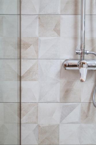 a shower in a bathroom with a glass door at Villa Athina in Preveza