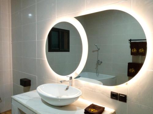 a bathroom with a white sink and a mirror at SOA LIA HOTEL in Miandrivazo