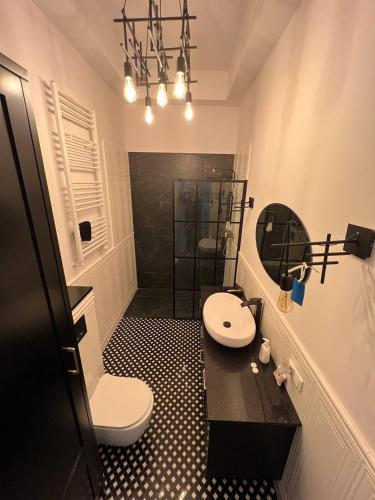 a bathroom with a toilet and a sink and a shower at Luxury Apartment In The City Center , Wi-Fi - by HIK Apartments in Warsaw