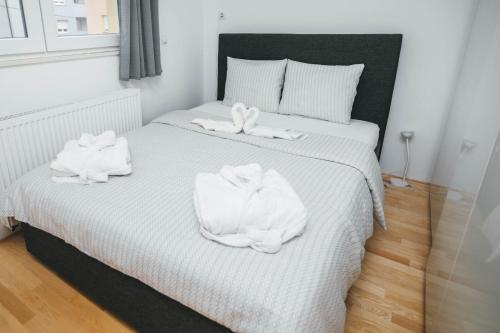 a bedroom with a bed with towels on it at New & Modern smart HOME, FREE parking in Zagreb