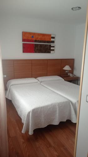 a bedroom with a white bed and a window at Hotel Molino in Ronda