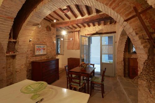 een keuken en eetkamer met een boog in een huis bij La Casina Del Lillotatini in Panicale