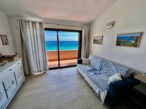 a living room with a couch and a view of the ocean at Casa Smeralda, Vista Mare Sea View in Fort Village
