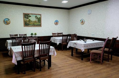 a dining room with tables and chairs in a restaurant at Donish Hotel in Bukhara