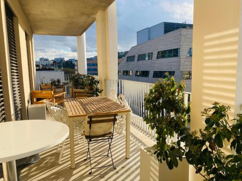 a balcony with a table and a table and chairs at Appartement T3 Confluence in Lyon