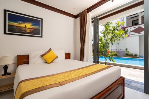 a bedroom with a bed and a swimming pool at Haemer Villa Hoi An in Hoi An