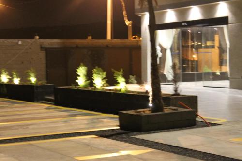 a building with a tree in the middle of a courtyard at High Village Hotel in Al Namas