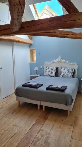 1 dormitorio con 1 cama en una habitación con suelo de madera en L'Angelus de Villiers, belle suite dans corps de ferme en Villiers-sous-Grez