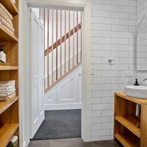 a bathroom with a sink and a white door at LUCAS Street in Kingston