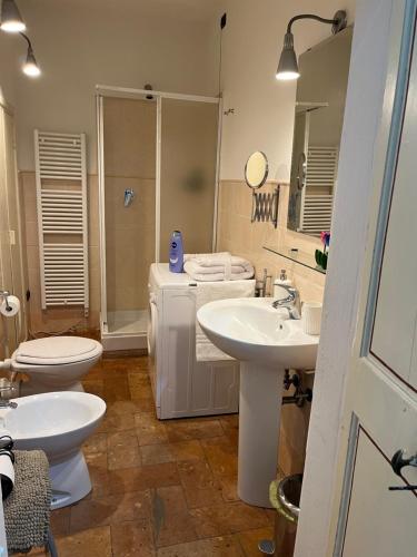 a bathroom with two sinks and a toilet and a shower at CASA DI SILVIA_MONOLOCALE in Città di Castello