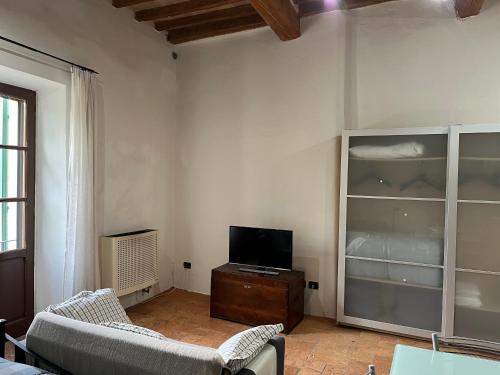 een woonkamer met een tv en 2 stoelen bij CASA DI SILVIA_MONOLOCALE in Città di Castello