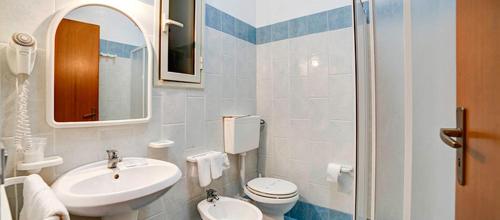 La salle de bains est pourvue d'un lavabo, de toilettes et d'un miroir. dans l'établissement Terme Acqua Pia, à Montevago