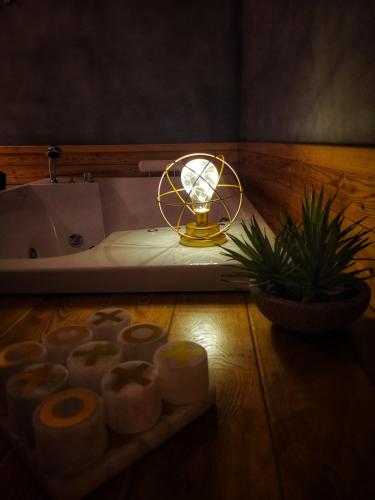 a bathroom with a bath tub with a light and a candle at Drì bed & breakfast in Rocca di Papa