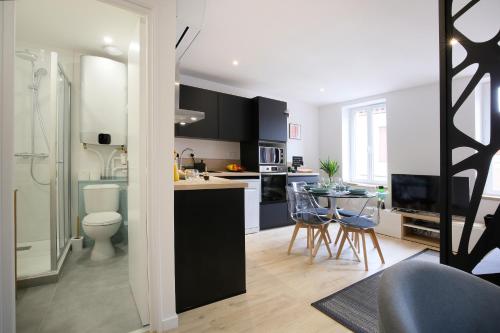 a kitchen and living room with a table and chairs at expat renting - Entre Piment & Violette - Saint Michel in Toulouse