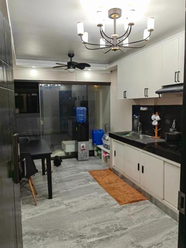 a kitchen with a sink and a table in it at You Can afford To Dwell Well in Manila