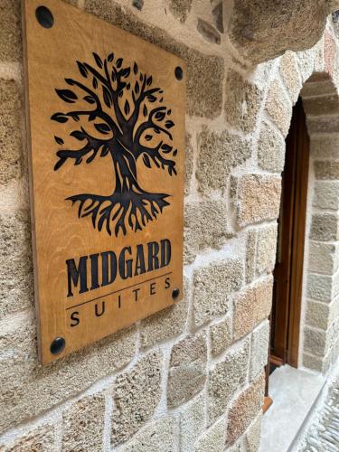 a sign for the middlegard switches on a brick wall at Midgard Suites (Medieval Town) in Rhodes Town