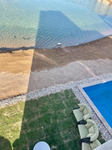 an aerial view of a swimming pool and the ocean at tawila T 31 in Hurghada