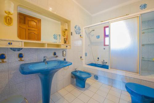 a bathroom with a blue sink and a toilet at Villa Lina - PlusHolidays in Calpe