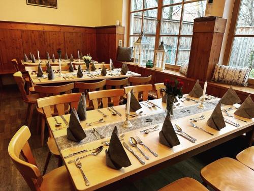 a large dining room with long tables and chairs at Alter Wirt Ramersdorf in Munich