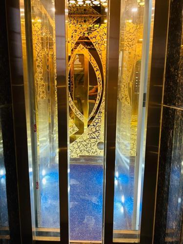 a glass door with a window with a mirror at Hotel RIVERB in New Delhi