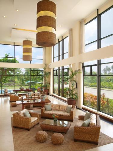 a large living room with large windows and couches at Hotel Kimberly Tagaytay in Tagaytay