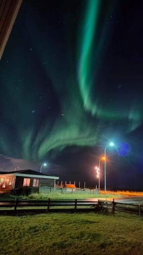 an image of the northern lights in the sky at Hótel Hafnir in Hafnir