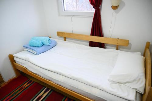 a bed with two towels on it in a room at Tri bagrema KM in Mokra Gora