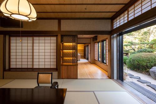 a hallway of a japanese home with a table and window at Hagi No Yado Tomoe in Hagi