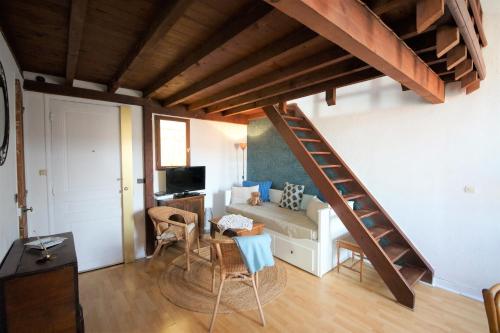 a living room with a staircase and a couch at Appartement le Mehari in Cassis
