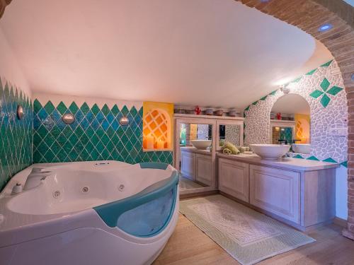 a bathroom with a large tub in a room at Sardinia Family Villas - Villa Elena with salt water private pool in Arzachena