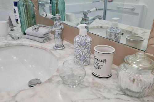 a bathroom counter with a sink and a mirror at L'Angelus de Villiers, belle suite dans corps de ferme in Villiers-sous-Grez