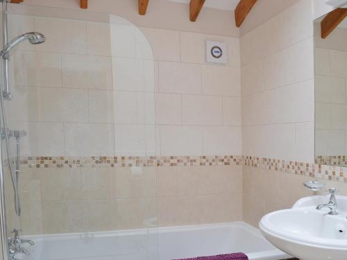 a bathroom with a shower and a sink at Wold View in Gristhorpe