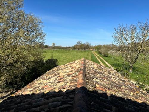 a roof of a building with a field in the background at Chambres d'hôtes du puy d'anché in Sauzé-Vaussais