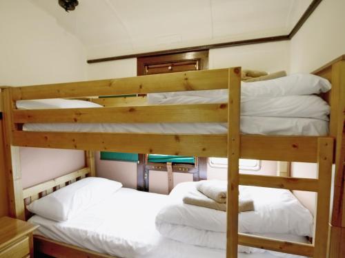 two bunk beds in a tiny house at Railway Carriage Two - E5601 in Wetheringsett