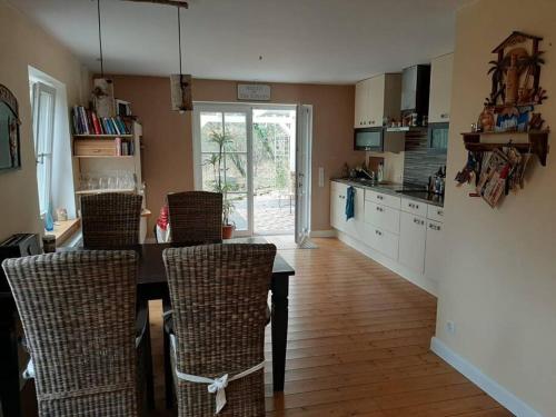 a kitchen with a table and chairs in a room at Ferienhaus Bad Arolsen in Bad Arolsen