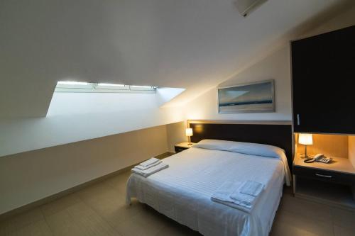 a bedroom with a large bed and a window at Sirina House Taormina in Taormina